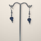 Dark Blue Small Earrings with sparkly navy beads and small dark beads on silver hooks, shown on a silver stand