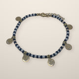 Happy Face & Black Charm Anklet with blue and white seed beads and silver smiley face charms, laid flat