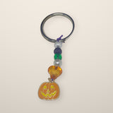 Orange Pumpkin Keychain with a smiling pumpkin charm, orange heart, green and purple beads on a silver ring