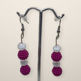 Purple Berry Drop Earrings - beaded drop earrings on hooks, shown on a silver stand