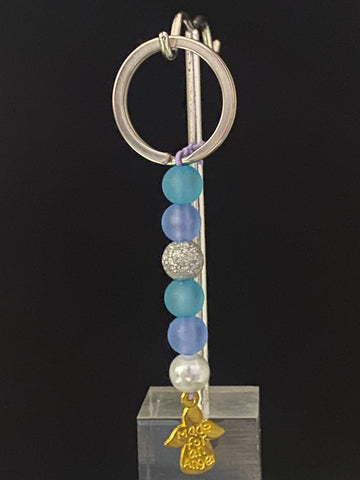 Light blue, dark purple, shiny grey, and white pearl with dangling angel  Keychain