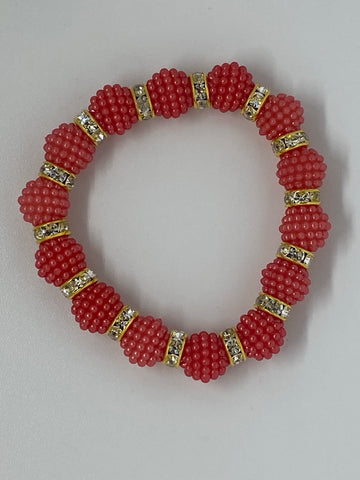 Red orange bracelet with diamonds in between