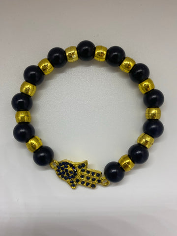 Black and gold bracelet with hand charm