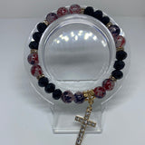 Black and red bracelet with dangling shiny cross