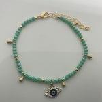 Green evil eye ankle bracelet with dangling evil eye charm 