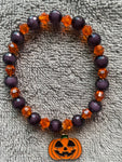 Black and orange shiny beads with dangling pumpkin charm