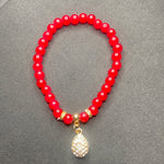 Red bracelet with shiny dangling bead