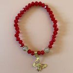 Red bracelet with gold dangling butterfly