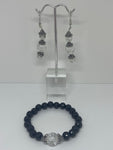 The bracelet has black pearls with glass bead marble in the middle and the earrings have three shiny clear glass beads with flower crown  Jewelry set