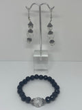 The bracelet has black pearls with glass bead marble in the middle and the earrings have three shiny clear glass beads with flower crown  Jewelry set