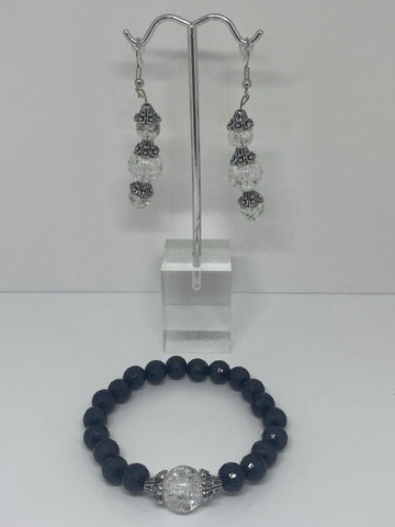 The bracelet has black pearls with glass bead marble in the middle and the earrings have three shiny clear glass beads with flower crown  Jewelry set