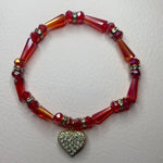 Red beads with dangling gold shiny heart