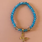 Baby blue bracelet with gold dangling butterfly