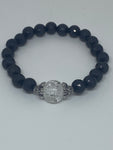 The bracelet has black pearls with glass bead marble in the middle 