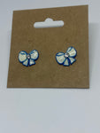 White bow with baby blue outline stud earrings