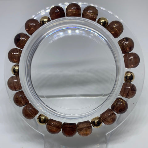 Brown bracelet with gold 