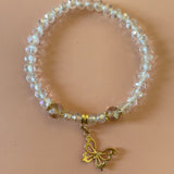 Clear bracelet with gold dangling butterfly