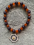 Black and orange shiny beads with dangling spider web 