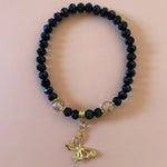 Black bracelet with gold dangling butterfly 