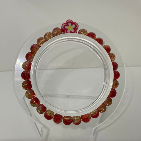 Ombré red glass beads and red orange charm in the middle 