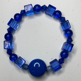 Blue circle and squared beads with blue circle charm